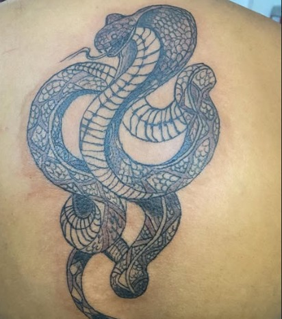 Detailed cobra back tattoo by PRANA Tattoo and Piercing Studio in Vellore